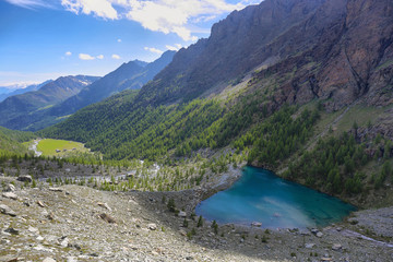 Blu lake in and alpine forest near Saint Jacques, Italy