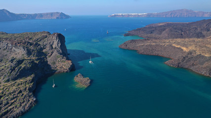 Fototapeta na wymiar Aerial drone top down photo of iconic main Crater of Santorini volcanic island called Kameni visited by tourist boats, Cyclades, Greece