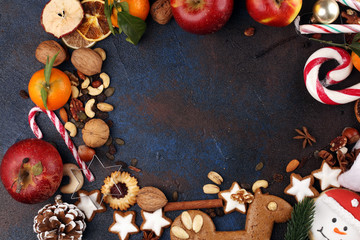 christmas cookies and santa had with spieses, nuts and fruits on rustic table