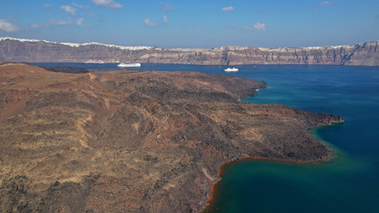 Aerial drone top down photo of iconic main Crater of Santorini volcanic island called Kameni visited by tourist boats, Cyclades, Greece