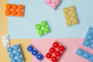 Some toy bricks on colored background. Colored toy bricks with place for your content