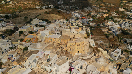 Aerial drone photo of iconic small traditional village and castle of Emporio in the heart of Santorini island, Cyclades, Greece