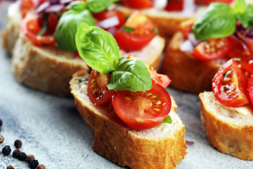 fresh tomato bruschetta. italian food appetizer with basil on table