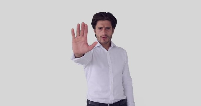 Annoyed businessman shouting and making stop sign with palm of hand
