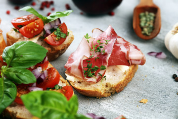 Assorted bruschetta with various toppings. Appetizing bruschetta or crudo crostini. Variety of small sandwiches. Mix bruschetta on table