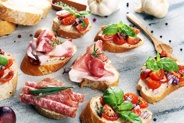 Assorted bruschetta with various toppings. Appetizing bruschetta or crudo crostini. Variety of small sandwiches. Mix bruschetta on table