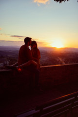 romantic smiling couple enjoying together on romantic sunset.