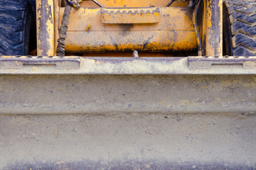 small scratched bulldozer. construction equipment. fruitful work concept. small tractor after work. work concept