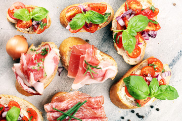 Assorted bruschetta with various toppings. Appetizing bruschetta or crudo crostini. Variety of small sandwiches. Mix bruschetta on table