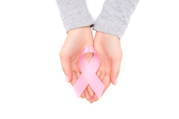 Girl hands holding pink breast cancer awareness ribbon on white isolated background. Concept healthcare and medicine