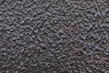 Concrete wall with corrugations painted in black color
