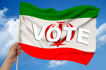 beautiful colored national flag of state of Iran on textural fabric, concept of tourism, economy and politics, closeup