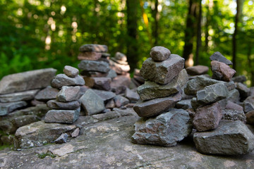 Fototapeta na wymiar Stones stacked in the forest