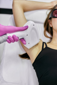 Kaliningrad, Russia - October 10, 2019: Young girl on a laser hair removal session. Laser Hair Removal Cabinet