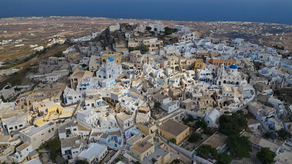Aerial drone photo of iconic small traditional village and uphill castle of Pyrgos with great views to Santorini island Cladera, Cyclades, Greece
