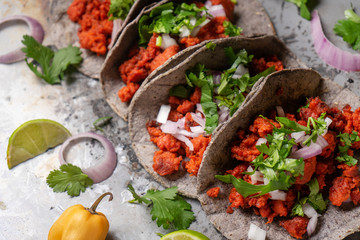 Mexican chorizo tacos with blue corn tortillas on rustic background