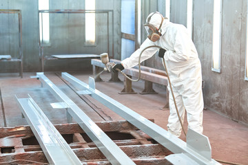 industrial painter in chamber painting metal detail