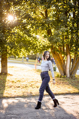 beautiful girl with long hair smiles nicely in the autumn park, fur coat, fur