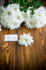 bouquet of white chrysanthemums on wooden table