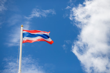 The Thai flag is flying with a beautiful background in the sky and clouds in Thailand.