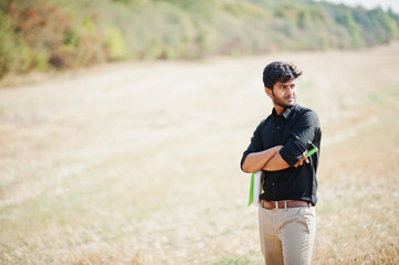 South asian agronomist farmer inspecting wheat field farm. Agriculture production concept.