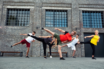 Coach teaching his group if trainees about leg kicks