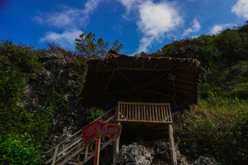 Beautiful view of the ocean and Green Hill on white clouds and blue sky background with the inscription ' I love you ' in Kebumen, Central Java, Indonesia