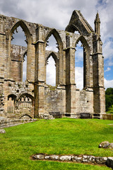 Fototapeta na wymiar Empty stone window ruins of Bolton Priory church a 12th century Augustinian monastery at Bolton Abbey Wharfedale North Yorkshire England