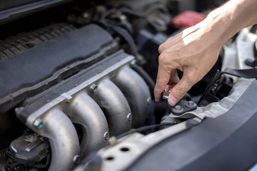 Man hand checking level of coolant car engine. Service and maintenance car or vehicle.