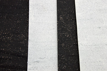 This is a photograph of a shiny textured Black and White striped background created using acrylic paint and glitter