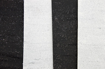 This is a photograph of a shiny textured Black and White striped background created using acrylic paint and glitter
