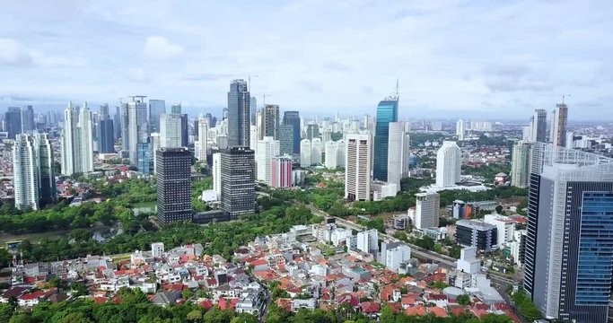 JAKARTA, Indonesia - October 18, 2019: Beautiful aerial hyperlapse of business district with modern buildings. Shot in 4k resolution from a drone flying forwards