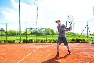 Fototapeta na wymiar Young man training and playing tennis