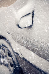 Naklejka na ściany i meble Cars covered by snow on street in winter day