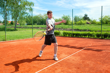 Young man training and playing tennis