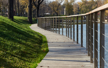 Footpath on the bank of the pond in the park area.