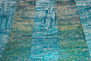 Fototapeta na wymiar This is a photograph of an abstract background created by organizing stripes created using Blue,turquoise,green,pink and gold glitter paint