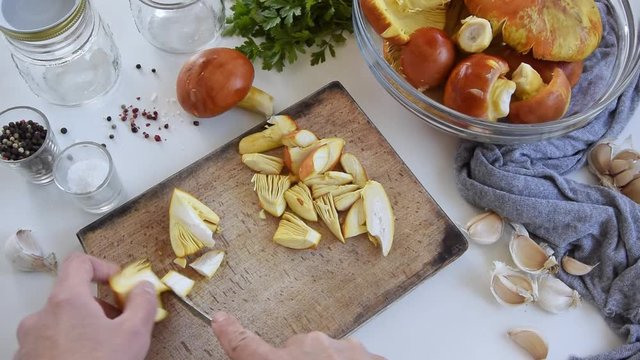 Personal perspective of woman hands cooking Amanita caesarea (known as Caesar's mushroom)