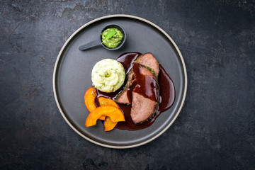 Traditional roasted beef heart with fried pumpkin slices, chimichurri and spicy chili sauce as top...