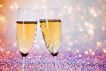 New Years eve concept with bokeh, fireworks and glasses of champagne. 