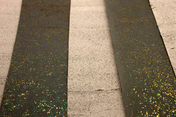 This is a photograph of a shiny textured Black and Beige striped background created using acrylic paint and gold and Bronze glitter