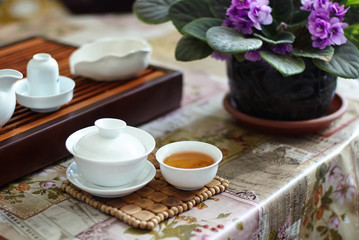 Chinese tea in a bowl on the table with flowers