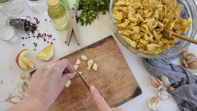 Personal perspective of woman hands cooking Amanita caesarea (known as Caesar's mushroom)