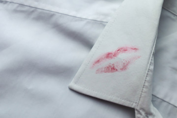 Dirty lipstick stain on white shirt. Stain remover concept