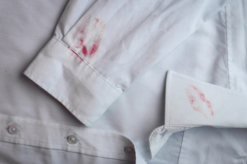 Dirty lipstick stain on white shirt. Stain remover concept