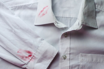 Dirty lipstick stain on white shirt. Stain remover concept