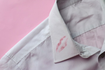 Dirty lipstick stain on white shirt. Stain remover concept