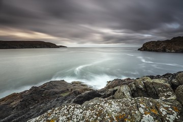 Gloomy scenery of the ocean with mountains surrounding it in Lewis, Outer Hebrides, Scotland, UK