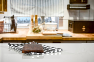 Kitchen table top with empty space for you products or decoration and blurred kitchen furniture background.