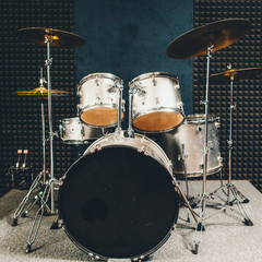 Modern sound recording studio. Musical instruments. Professional drum set on stage. Copy space.